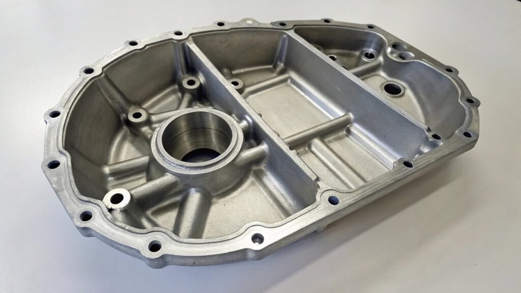 A microscopic view showing the dense, uniform grain of forged aluminum next to the porous, coarse grain of cast aluminum.